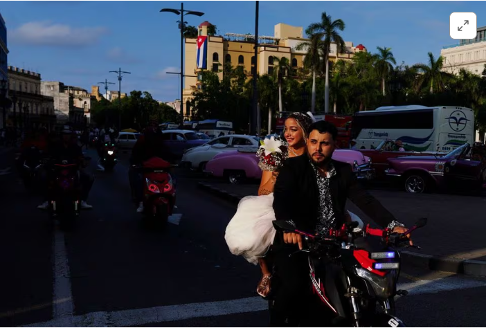 Electricity in the air for one Cuban couple's two-wheeler wedding procession